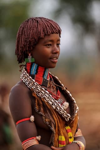 A Hamer woman in shell and bead necklaces